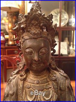 A Rare and Important Early Chinese Bronze Guanyin Statue with Wooden Stand