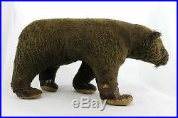 An old straw filled brown teddy bear. Walking posture. Early 20th century. Rare