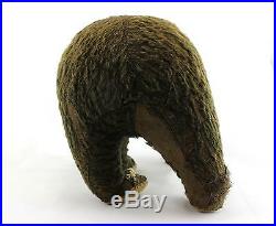 An old straw filled brown teddy bear. Walking posture. Early 20th century. Rare