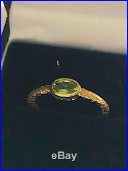 Antique early 19C gold and peridot ring with textured shank. Size N. Rare