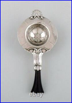 Early and rare art nouveau Georg Jensen tea strainer in silver with ebony handle