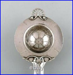 Early and rare art nouveau Georg Jensen tea strainer in silver with ebony handle