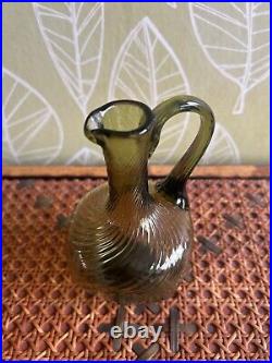 Early blown green glass textured one handled jug, 16cms height, rare item